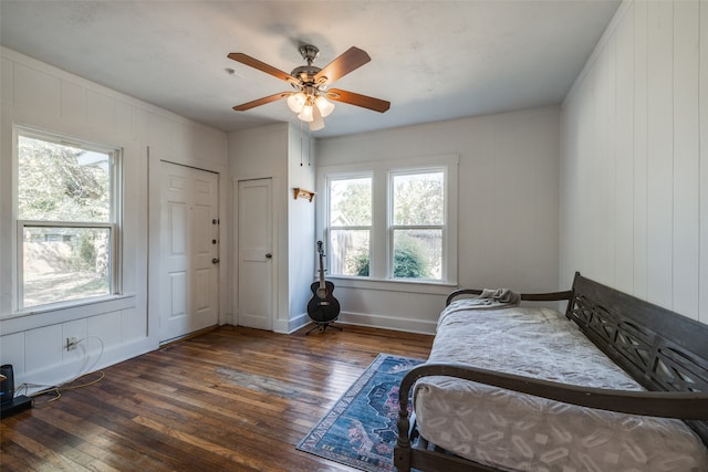 bedroom featuring multiple windows, ceiling fan, and dark hardwood / wood-style floors