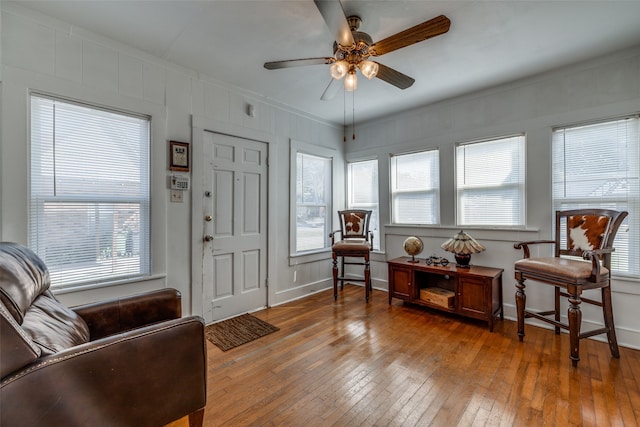 entrance foyer featuring ceiling fan, a wealth of natural light, hardwood / wood-style floors, and ornamental molding