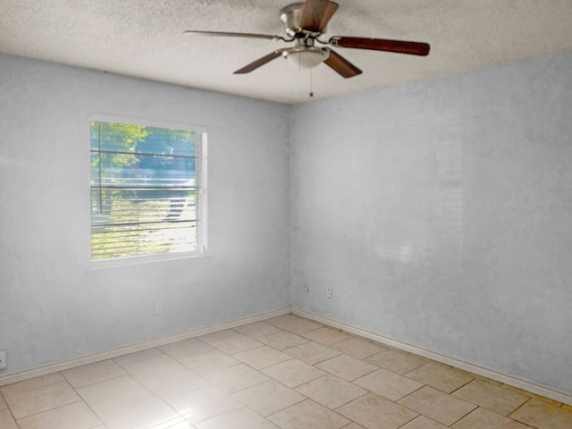 spare room featuring ceiling fan and a textured ceiling