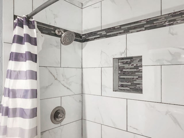 interior details featuring a shower with curtain