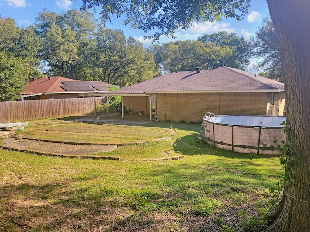 view of yard with a fenced in pool