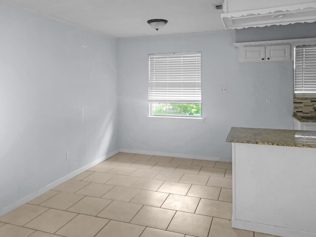 unfurnished dining area with light tile patterned floors