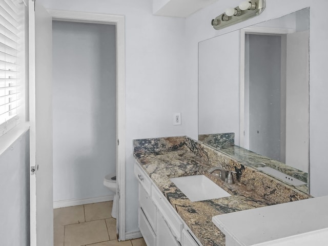 bathroom featuring vanity, tile patterned flooring, and toilet