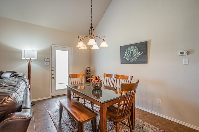 tiled dining room featuring a chandelier and lofted ceiling