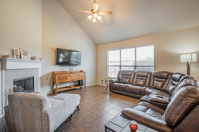 tiled living room featuring ceiling fan, a fireplace, and high vaulted ceiling