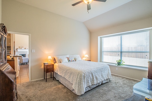 bedroom featuring ceiling fan, carpet floors, and vaulted ceiling