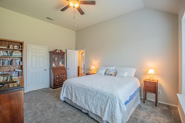 bedroom with vaulted ceiling, dark carpet, and ceiling fan