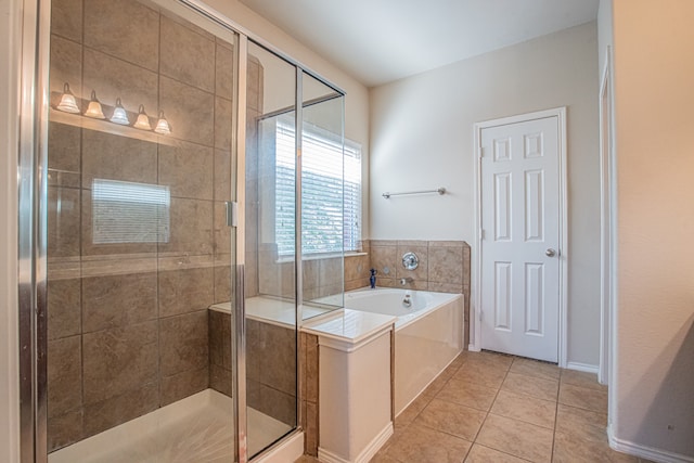 bathroom with tile patterned floors and independent shower and bath