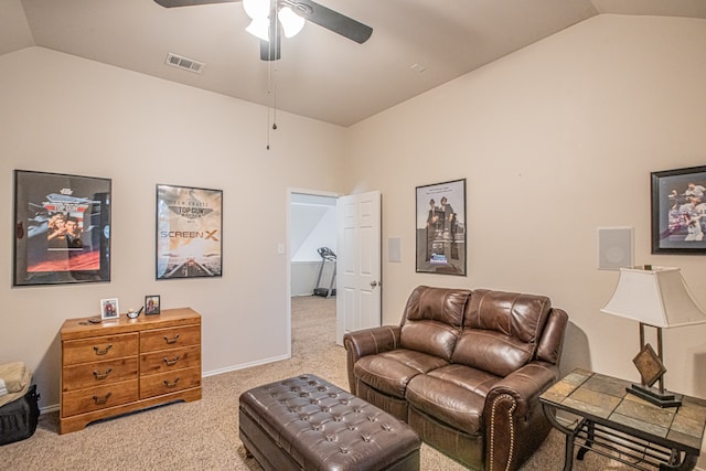 living room with ceiling fan, light colored carpet, and vaulted ceiling