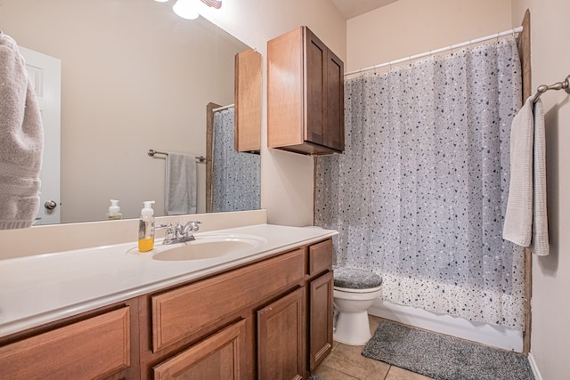 full bathroom with tile patterned flooring, shower / bath combination with curtain, vanity, and toilet