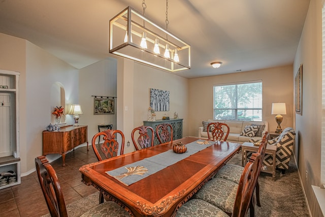 tiled dining room featuring a notable chandelier