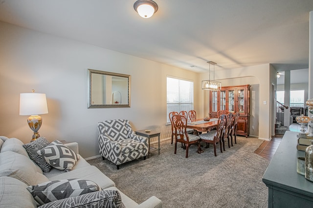 carpeted living room with a chandelier