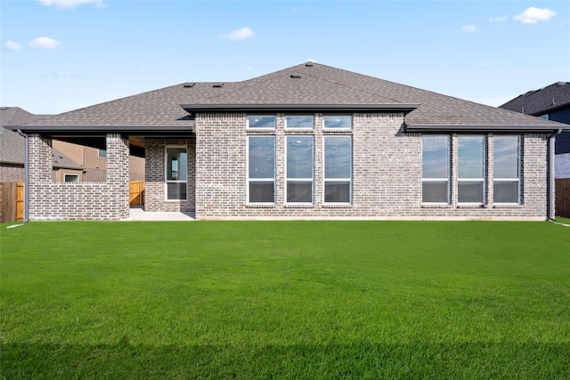 rear view of house featuring a lawn