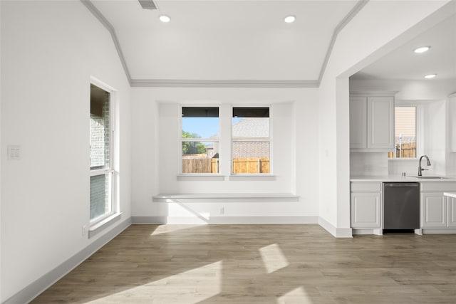 interior space with light hardwood / wood-style floors, ornamental molding, sink, and plenty of natural light