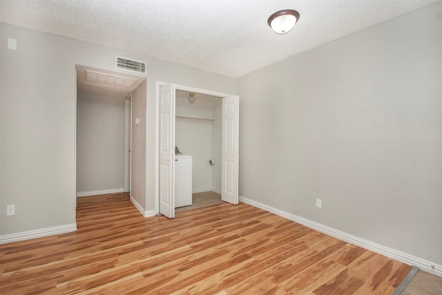 unfurnished bedroom featuring a closet, light hardwood / wood-style floors, and a textured ceiling