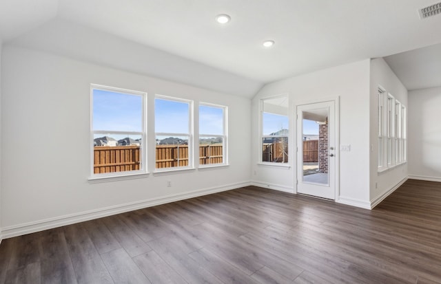 additional living space featuring lofted ceiling and dark hardwood / wood-style floors