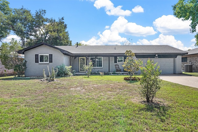 ranch-style home featuring a garage, a front lawn, and central air condition unit