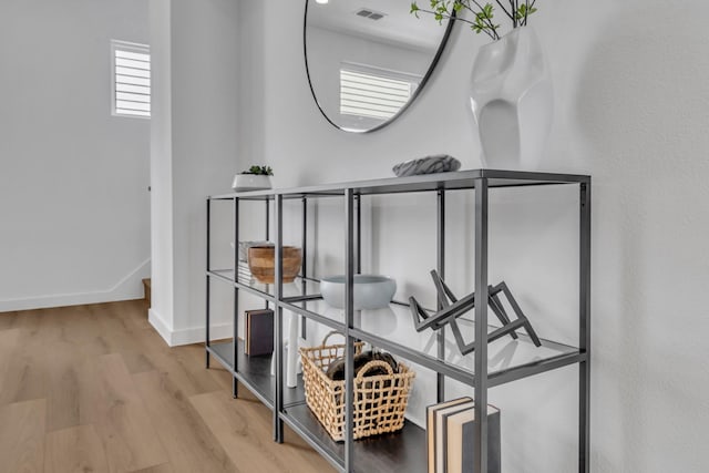 room details with visible vents, baseboards, and wood finished floors