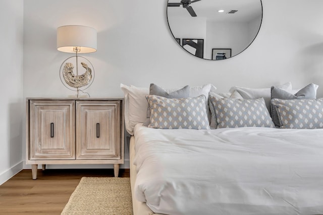 bedroom featuring baseboards and wood finished floors