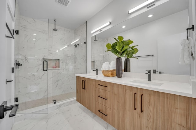 full bath featuring marble finish floor, a marble finish shower, recessed lighting, visible vents, and a sink