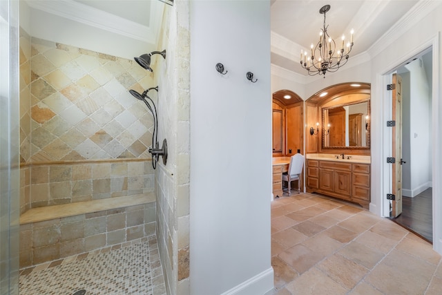 bathroom with a tile shower, crown molding, vanity, and an inviting chandelier