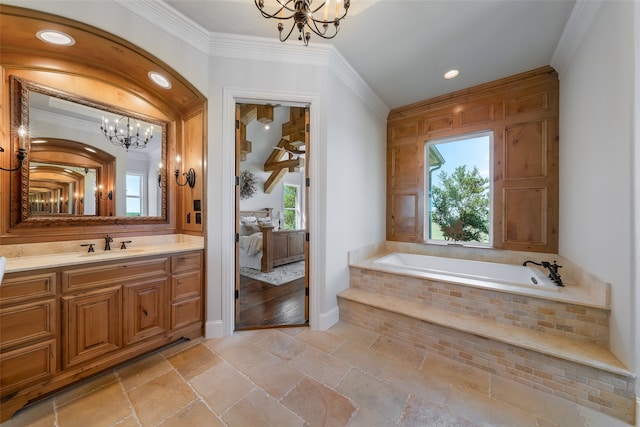 bathroom with vanity, tiled bath, crown molding, and a notable chandelier