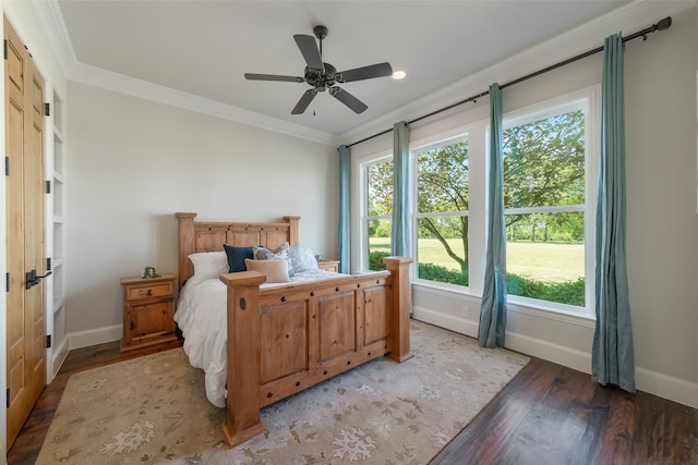 bedroom featuring hardwood / wood-style floors, ceiling fan, and ornamental molding