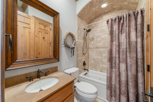 full bathroom featuring shower / bath combo with shower curtain, vanity, and toilet