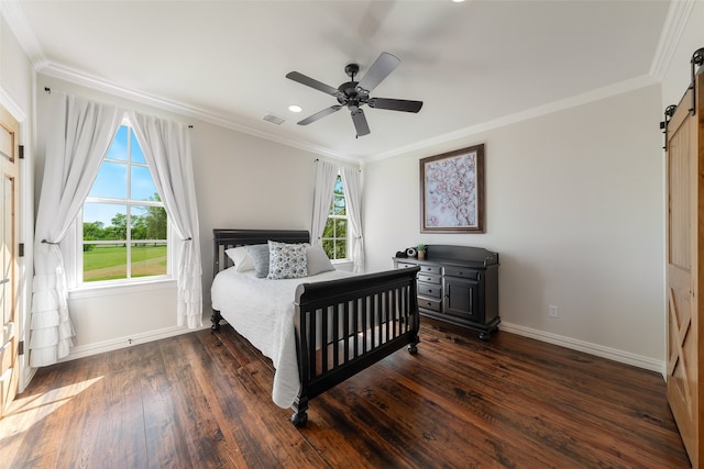 bedroom featuring multiple windows, ceiling fan, dark wood-type flooring, and a barn door