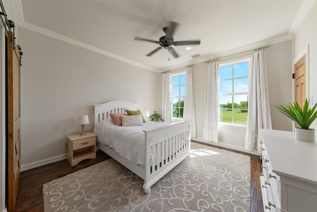 bedroom with ornamental molding, a barn door, ceiling fan, and dark wood-type flooring