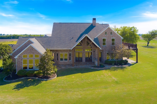 back of house featuring a yard