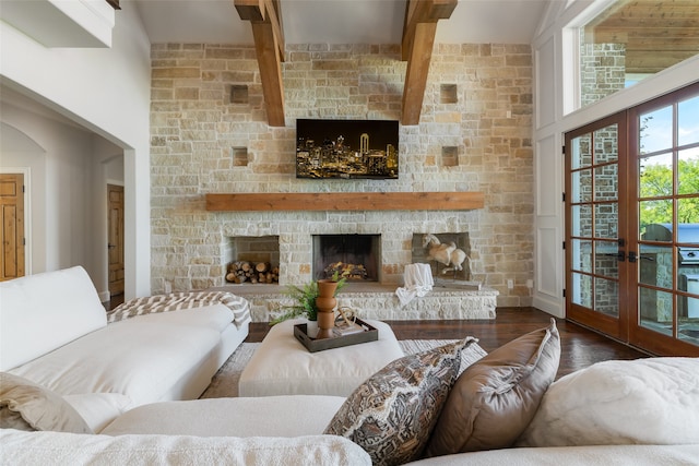 living room featuring a stone fireplace, dark hardwood / wood-style flooring, and french doors