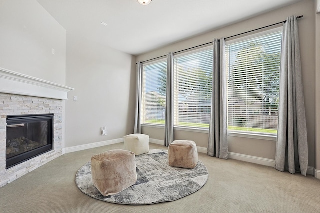 sitting room featuring plenty of natural light and light colored carpet