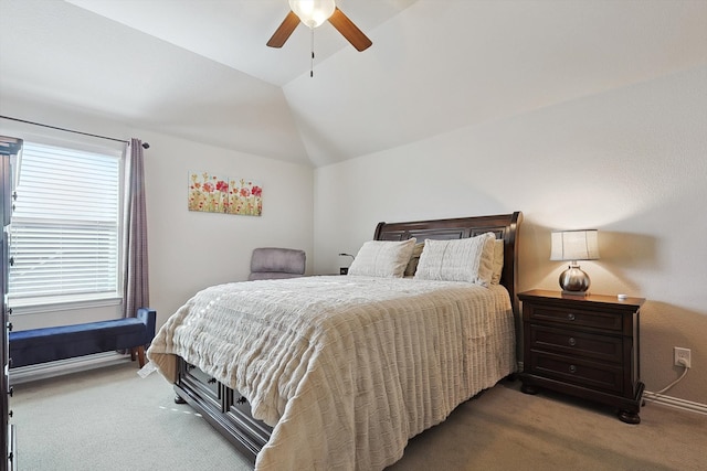 bedroom with ceiling fan, vaulted ceiling, and carpet