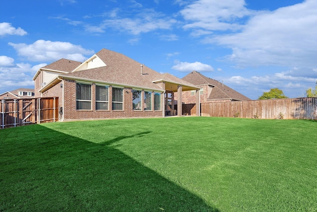 rear view of property with a lawn