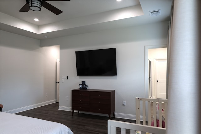 bedroom with ceiling fan and dark wood-type flooring