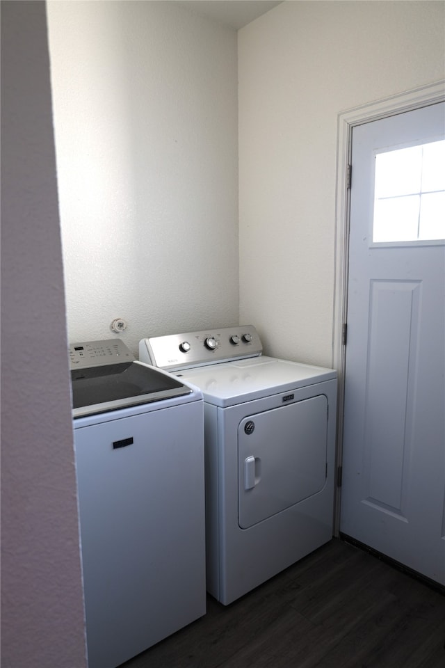 laundry area with dark wood-type flooring and washing machine and clothes dryer