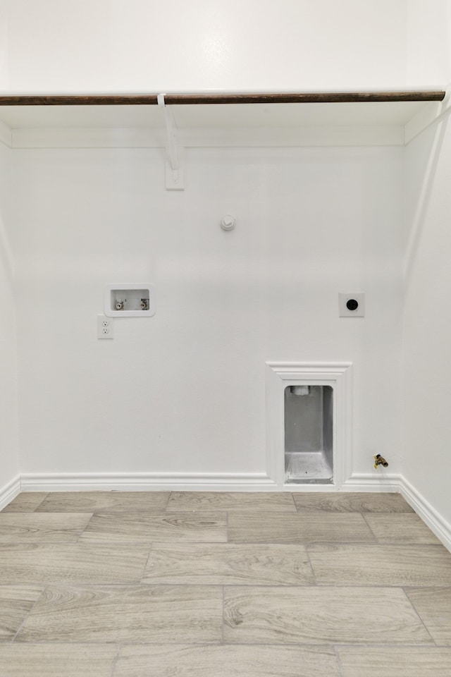 laundry area featuring washer hookup, hookup for an electric dryer, gas dryer hookup, and light wood-type flooring