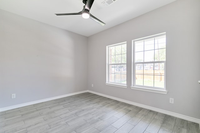 empty room with light hardwood / wood-style floors and ceiling fan