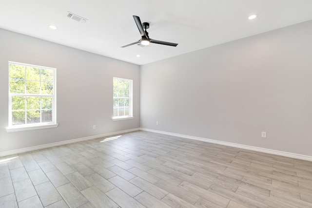 spare room featuring ceiling fan and light hardwood / wood-style floors