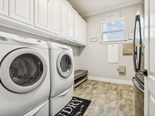 laundry area with crown molding, cabinets, and washer and dryer