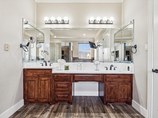 bathroom featuring vanity, wood-type flooring, and crown molding