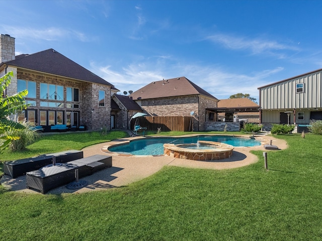 view of swimming pool featuring an in ground hot tub and a lawn