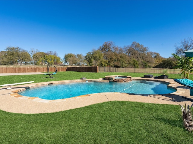 view of pool featuring a diving board, a yard, and an in ground hot tub