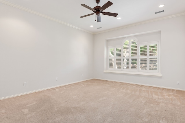 empty room with ceiling fan, ornamental molding, and light carpet