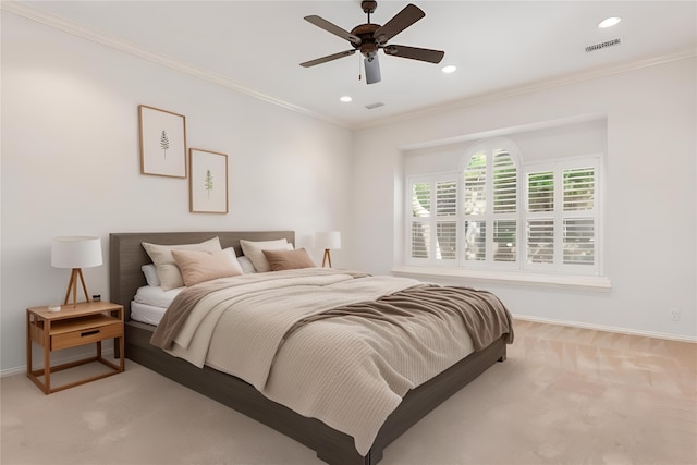 carpeted bedroom featuring ceiling fan and ornamental molding