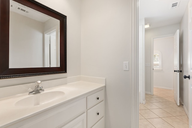 bathroom with tile patterned flooring and vanity