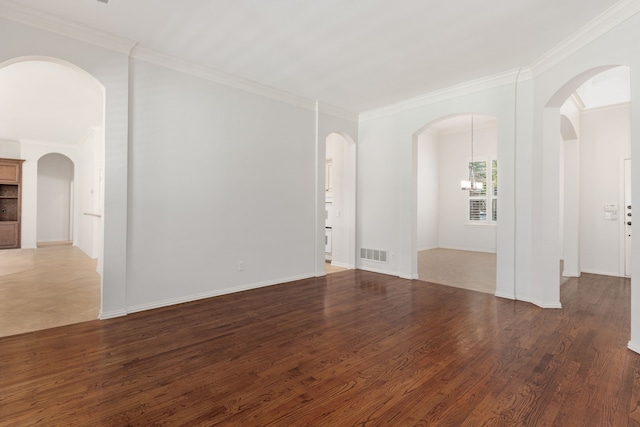 unfurnished room with a chandelier, dark wood-type flooring, and ornamental molding