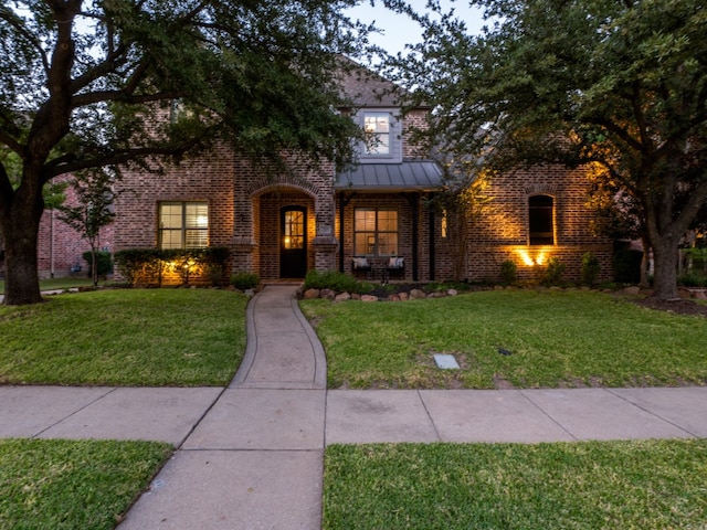 tudor-style house with a front yard