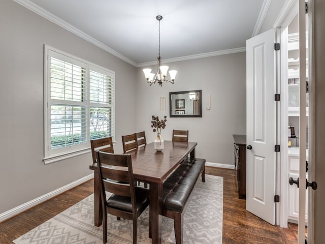 dining room with dark wood-type flooring, crown molding, and an inviting chandelier